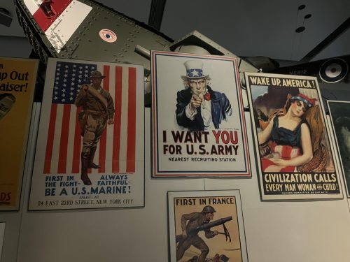 WWI and WWII military recruitment posters displayed in museum including iconic Uncle Sam I Want You Army poster