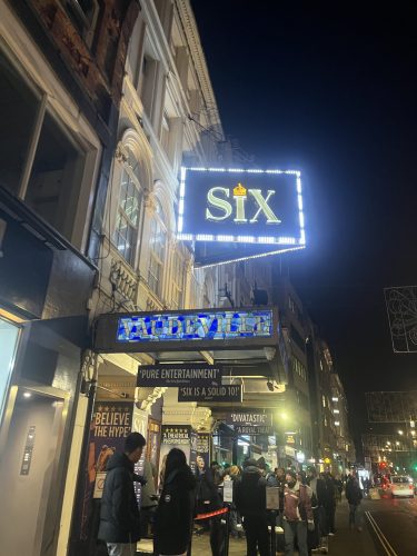 SIX musical theater marquee at Vaudeville Theatre in London's West End at night with crowd of theatergoers outside
